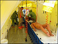 A Marine battalion simulates decontamination of bodies exposed to a deadly chemical weapon.