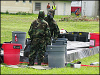Marine decontamination unit members prepare to sanitize an area during a simulated terrorist attack.