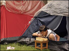 A young girl eats her lunch in her tent at a park in Chengdu, China. A young girl eats her lunch in her tent at a park in Chengdu, China.