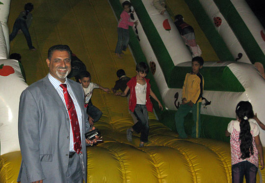 Hatim al-Bachary stands in front of one of the attractions at his newly opened amusement park.