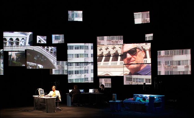 Child in bed, faces on screens in a scene from 'Continuous City'