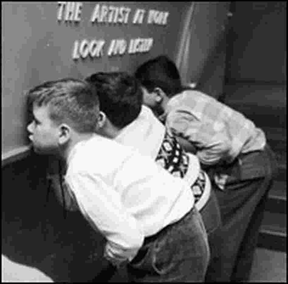Schoolchildren visiting the Junior Museum of the Metropolitan Museum of Art peer at slides.