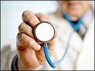 A man holds out a stethoscope. A man holds out a stethoscope.