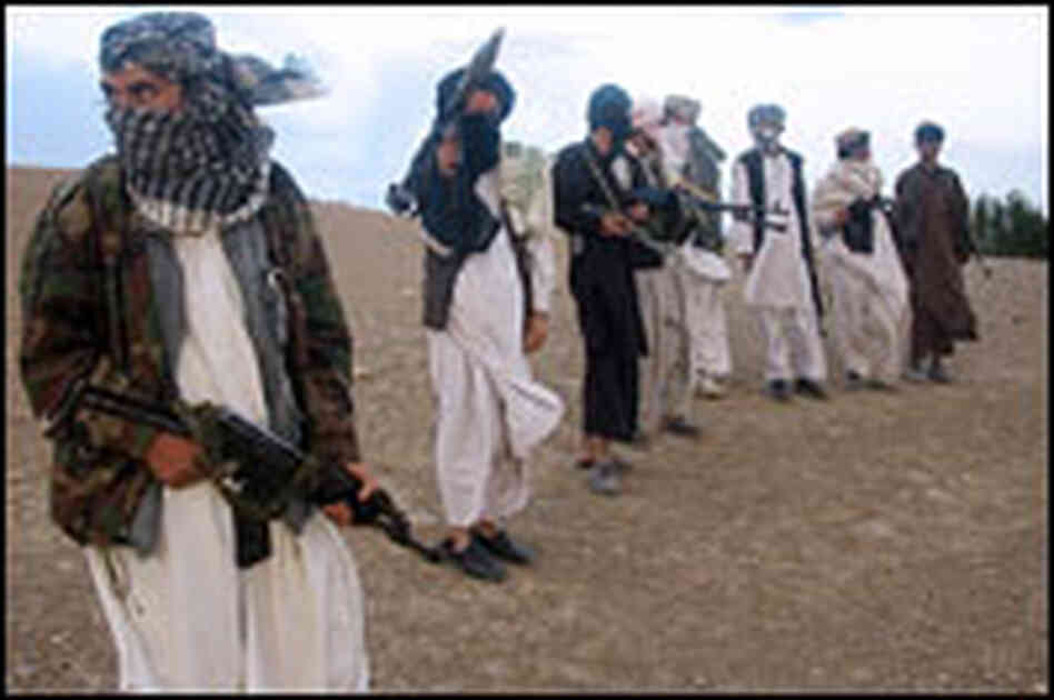 Fighters with Afghanistan's Taliban militia stand on a hillside in Wardak province on Sept. 26.