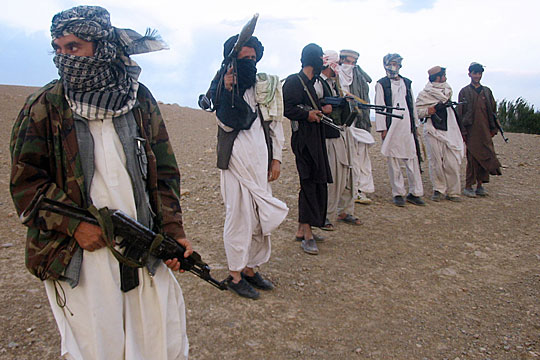 Fighters with Afghanistan's Taliban militia stand on a hillside in Wardak province on Sept. 26.