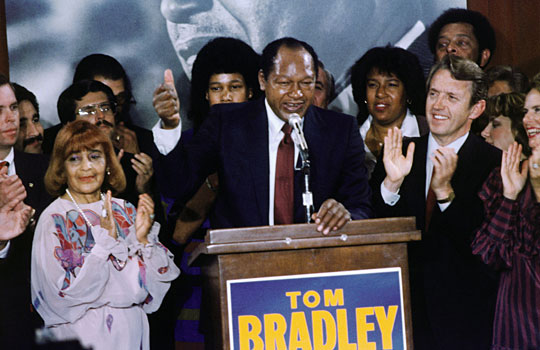 Los Angeles Mayor Tom Bradley stands with supporters during a campaign rally in November 1982.