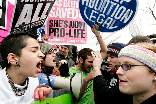 Abortion rights activists argue with abortion opponents.