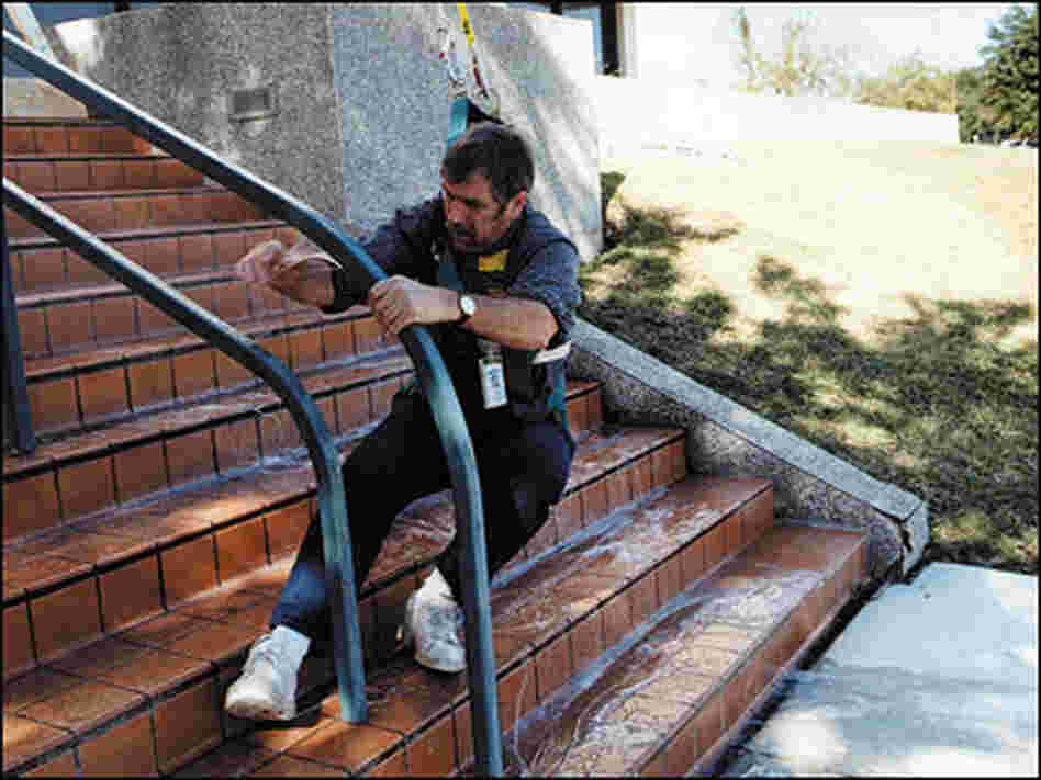 A man slips on a surface sprayed with anti-pirate coating. A man slips on a surface sprayed with anti-pirate coating.