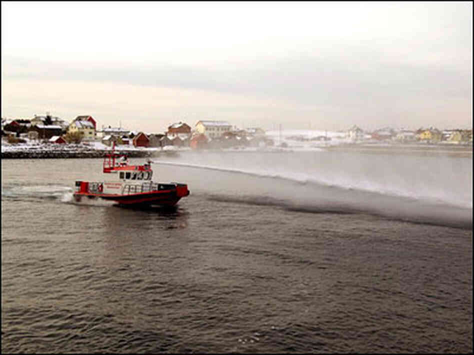A boat demonstrates the high-power water hose designed to keep pirates at bay. A boat demonstrates the high-power water hose designed to keep pirates at bay.