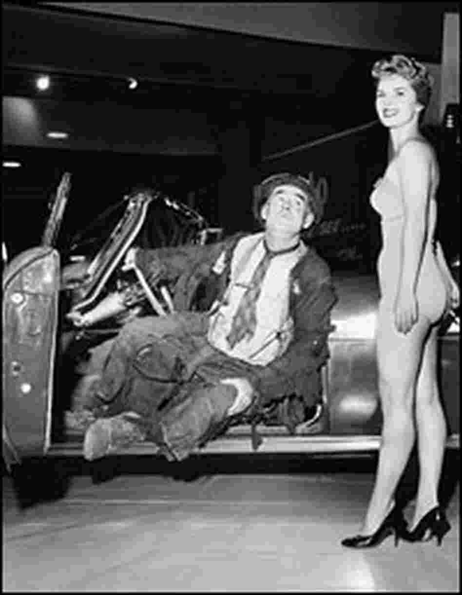 A model sports a nude swimsuit to promote Chrysler at the 1960 Detroit Auto Show.