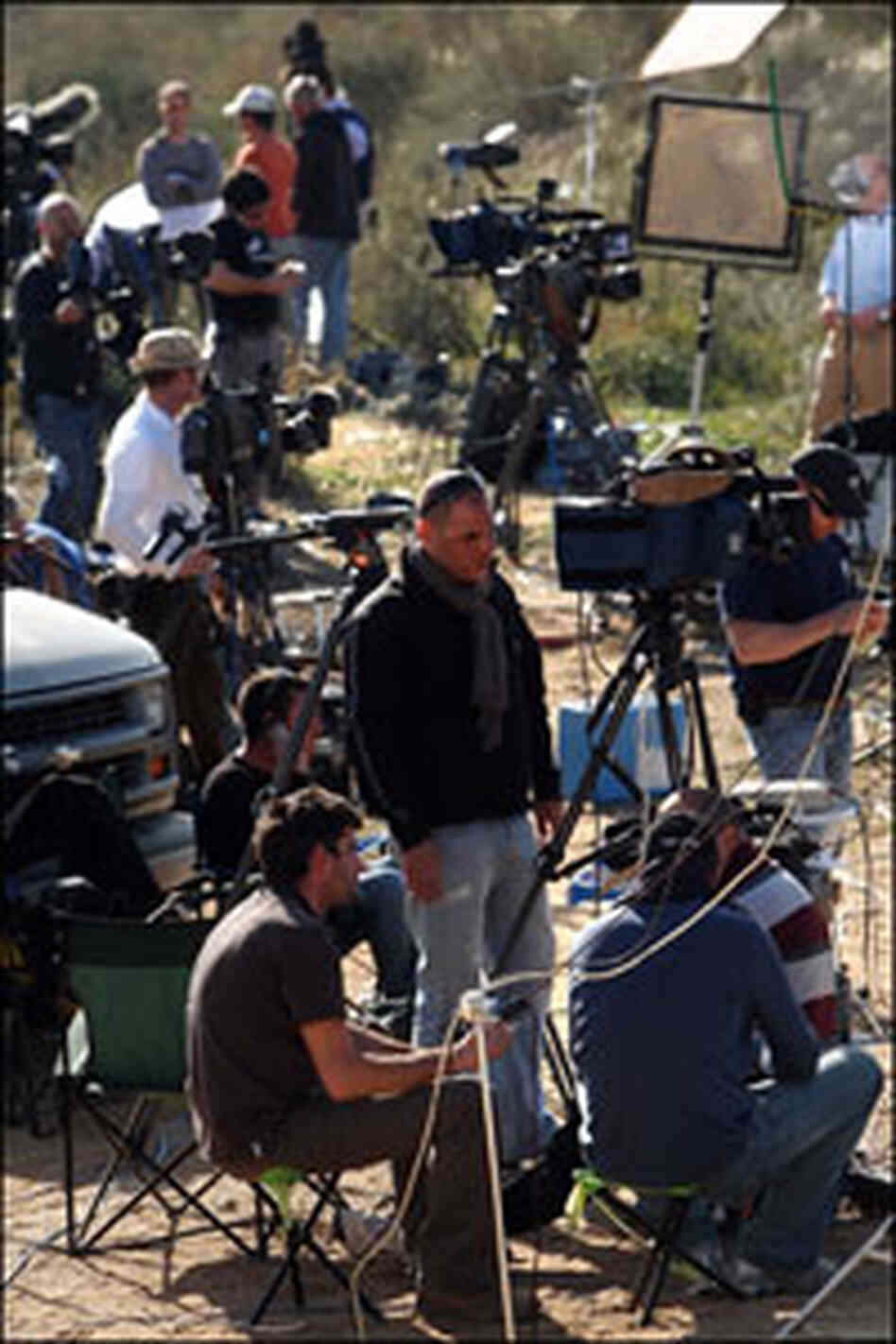 Members of the media report along the Israeli-Gaza border in Israel on Wednesday.