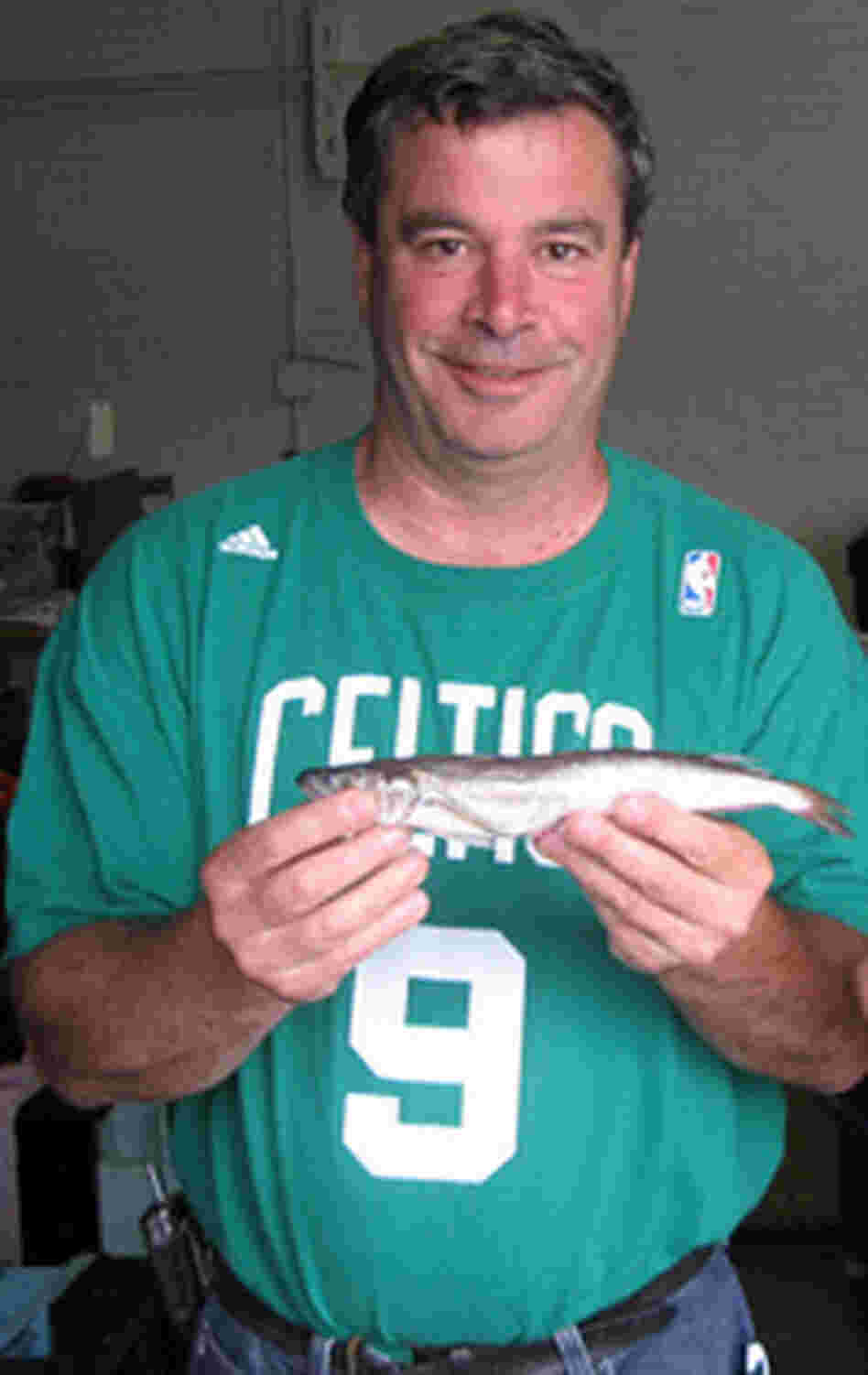 Steve Parkes, a community supported fishery organizer, holds a fish