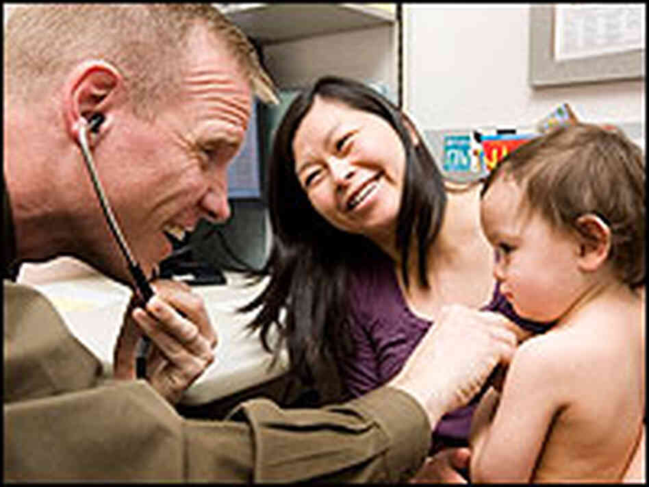A pediatrician from Group Health Cooperative checks a patient. A pediatrician from Group Health Cooperative checks a patient.