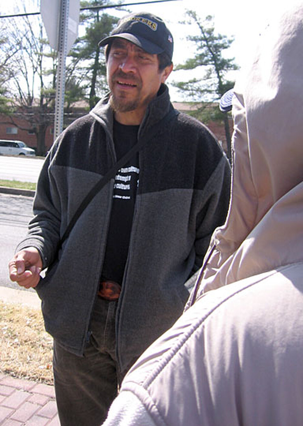 Arnoldo Borja, of the Legal Aid Justice Center, talks with immigrant day laborers in Annandale, Va.