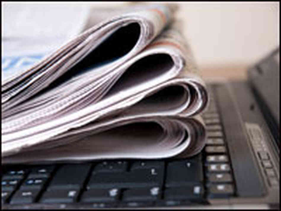 Newspaper with laptop Newspaper with laptop