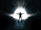 Person in a tunnel walking toward light. Person in a tunnel walking toward light.
