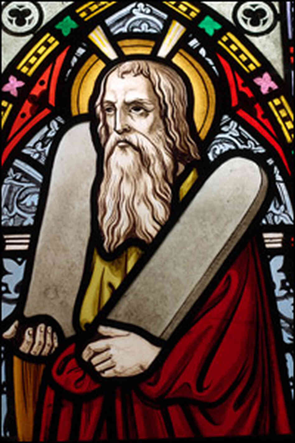 A stained glass window showing Moses holding the Ten Commandments.