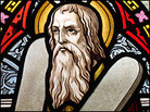 A stained glass window showing Moses holding the Ten Commandments. A stained glass window showing Moses holding the Ten Commandments.