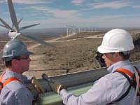Reporter Howard Berkes (R) atop a wind turbine