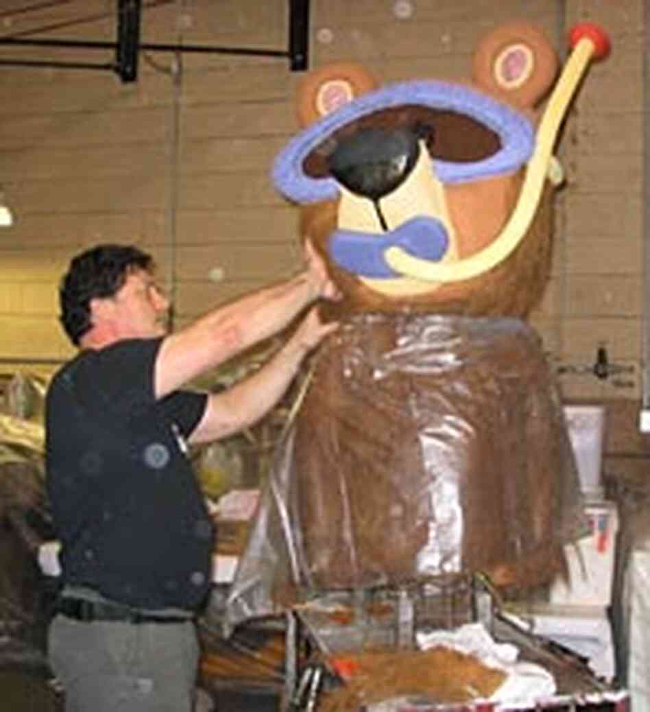 A volunteer puts the finishing touches on a petal-covered bear A volunteer puts the finishing touches on a petal-covered bear