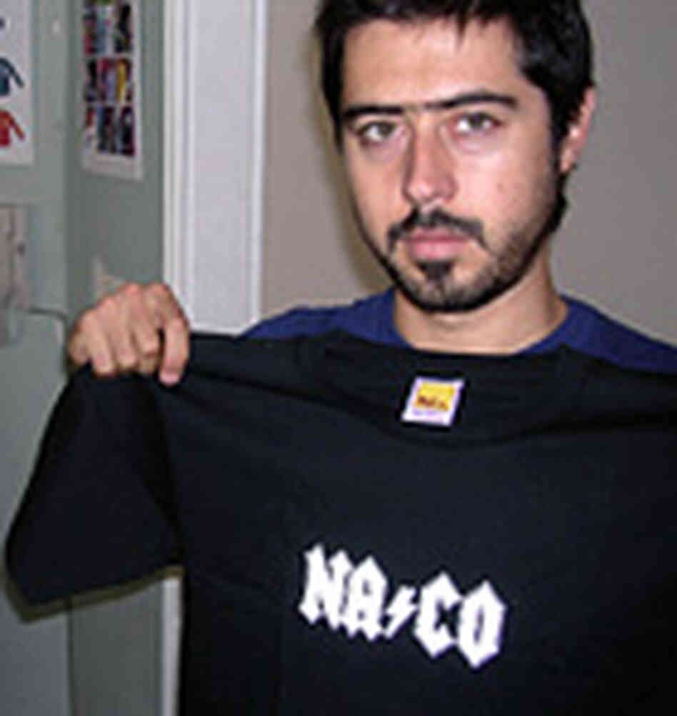 Carlos Meza holds a naco t-shirt. Carlos Meza holds a naco t-shirt.