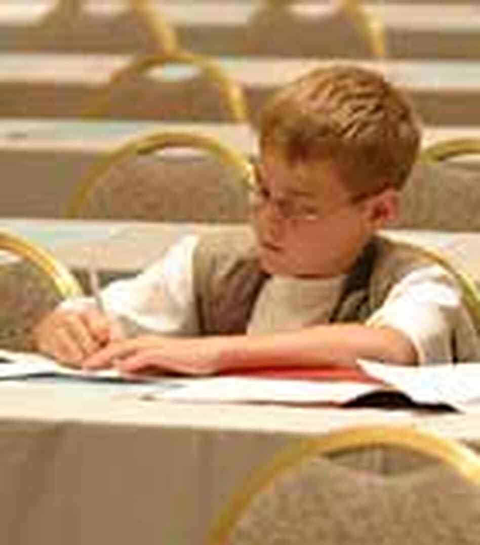A spelling bee competitor studies on the day before competition begins. A spelling bee competitor studies on the day before competition begins.