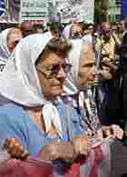 Members of the human rights group Mothers and Grandmothers of Plaza de Mayo march towards the ESMA b Members of the human rights group Mothers and Grandmothers of Plaza de Mayo march towards the ESMA b