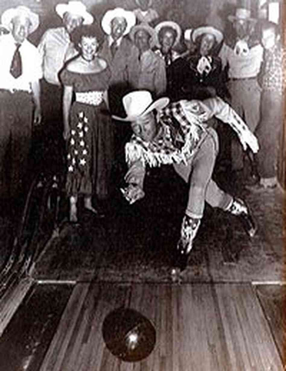 Roy Rogers tosses a bowling ball down the lanes at Pioneertown as a crowd cheers him on. Roy Rogers tosses a bowling ball down the lanes at Pioneertown as a crowd cheers him on.
