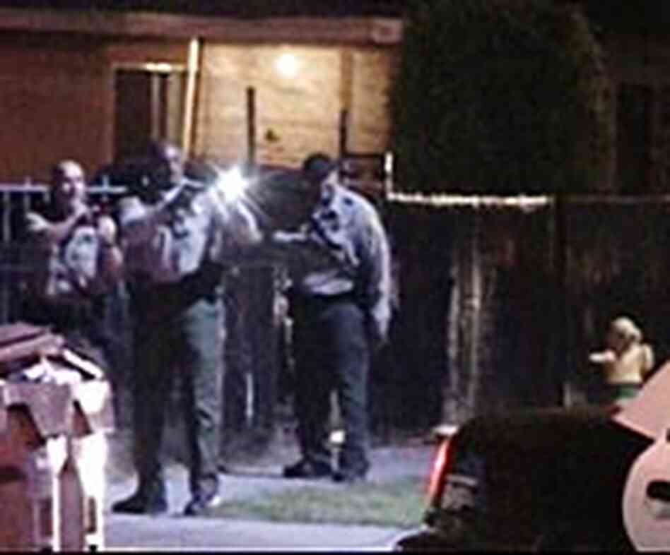 Officers approach a suspect's car in Compton, Calif., May 9, 2005. Officers approach a suspect's car in Compton, Calif., May 9, 2005.