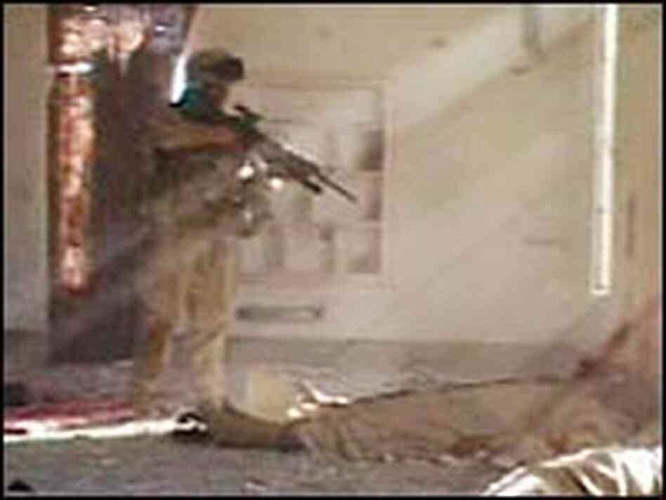 An unidentified U.S. Marine Corps corporal fires his weapon at an unarmed Iraqi, Nov. 13, 2005 An unidentified U.S. Marine Corps corporal fires his weapon at an unarmed Iraqi, Nov. 13, 2005
