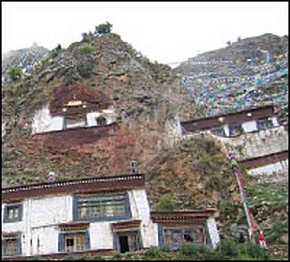 Prayer flags nearly cover a steep cliffside in Lhasa