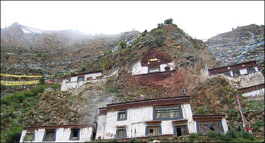 Prayer flags nearly cover a steep cliffside in Lhasa