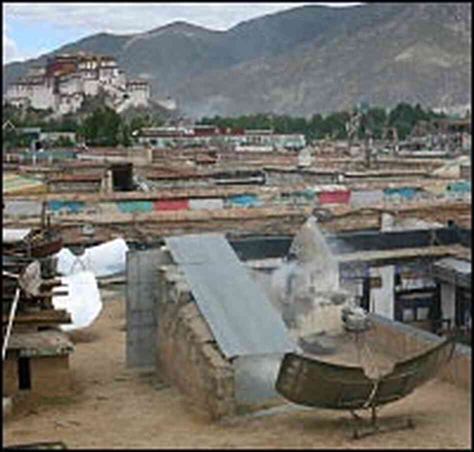 Satellite dish pulls signals from the sky, with the seemingly eternal Potola Palace in the backgroun