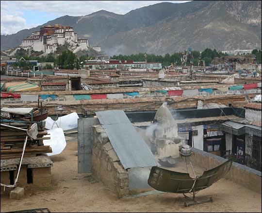 Satellite dish pulls signals from the sky, with the seemingly eternal Potola Palace in the backgroun