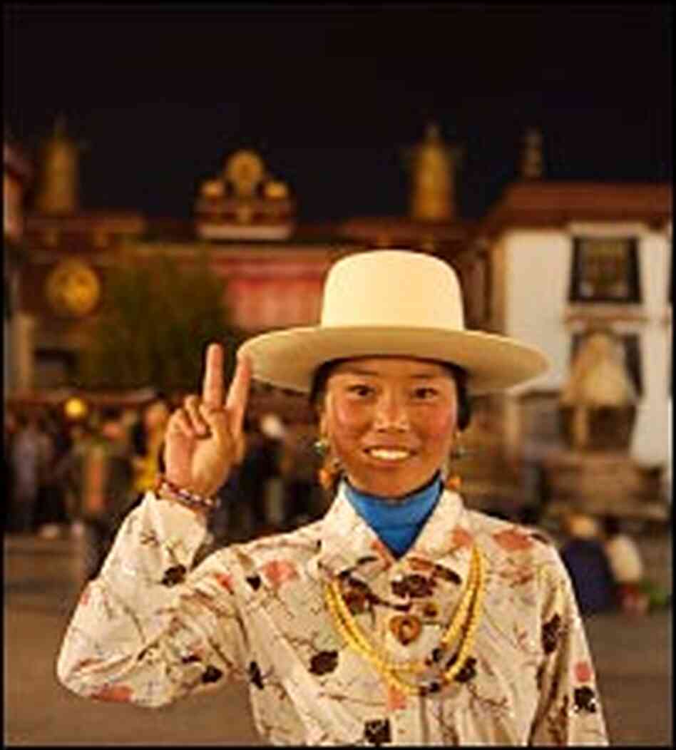 Tibetan woman mixes traditional dress with a comtemporary attitude. Tibetan woman mixes traditional dress with a comtemporary attitude.