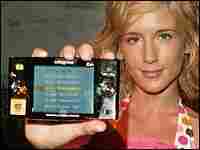 A model poses with the new TiVoToGo device. A model poses with the new TiVoToGo device.