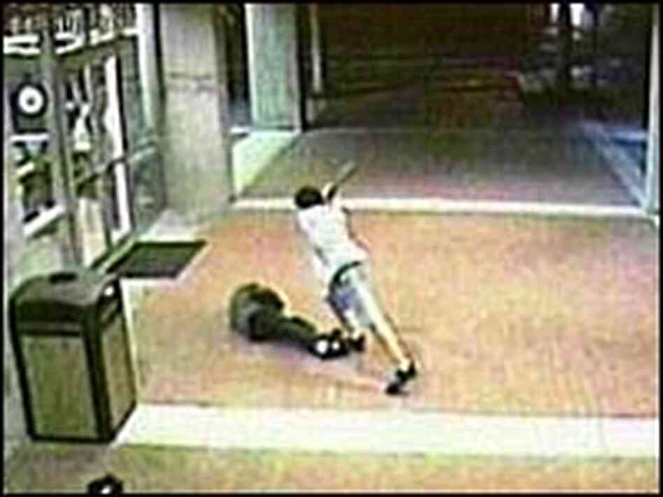One of the beating suspects swings a baseball bat at a homeless man. One of the beating suspects swings a baseball bat at a homeless man.