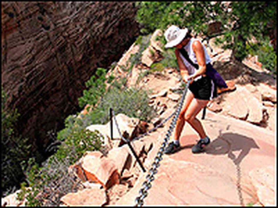 Hiker Lisa Miller grabs heavy chain near the top of the Grotto trailhead.