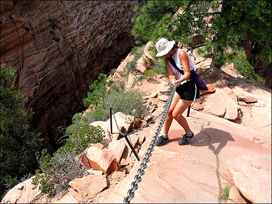 Hiker Lisa Miller grabs heavy chain near the top of the Grotto trailhead.
