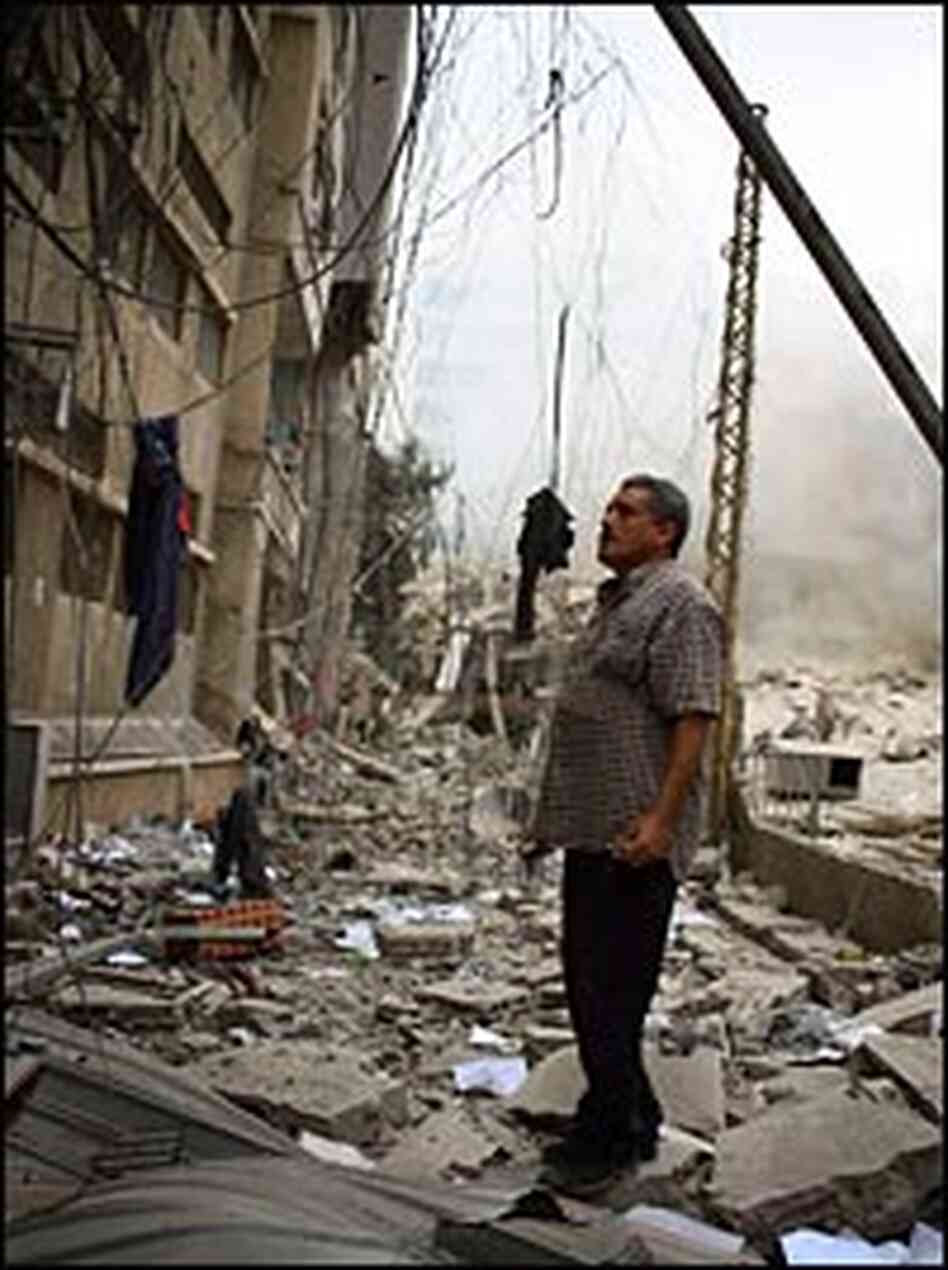 A resident of Beirut's southern suburbs, a Hezbollah stronghold, check damage after Israeli bombing A resident of Beirut's southern suburbs, a Hezbollah stronghold, check damage after Israeli bombing