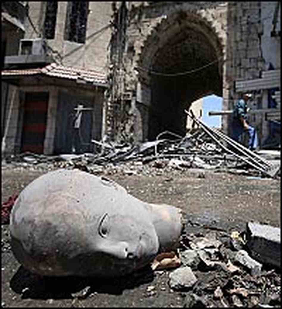 The disembodied head of a statue lies in the rubble of a site bombed by Israelis. The disembodied head of a statue lies in the rubble of a site bombed by Israelis.