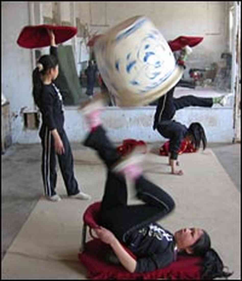 Teenage girls practice their acrobatic routines Teenage girls practice their acrobatic routines