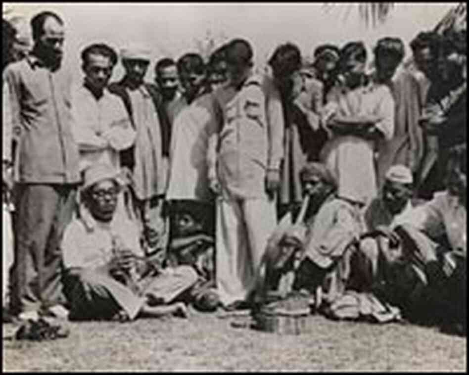 Dizzy Gillespie, sitting at left, with snake charmers in India. Dizzy Gillespie, sitting at left, with snake charmers in India.