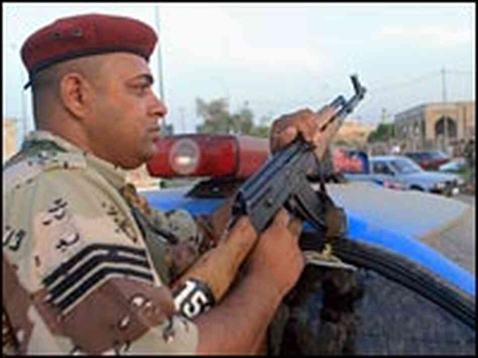 An Iraqi police commando scans a street in the southern city of Amara, Oct. 20, 2006. An Iraqi police commando scans a street in the southern city of Amara, Oct. 20, 2006.