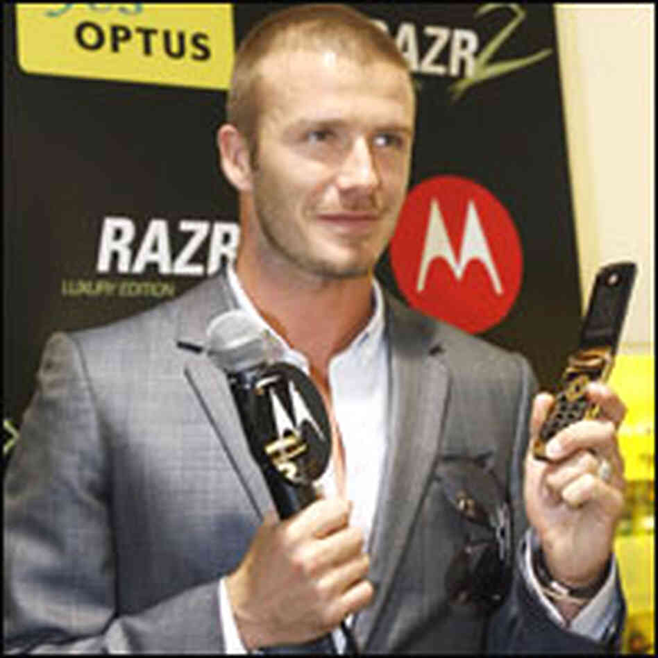 David Beckham Holds Cell Phone David Beckham Holds Cell Phone