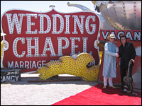 Phoenix poses with the wedding's Elvis impersonator at the Las Vegas Neon Museum