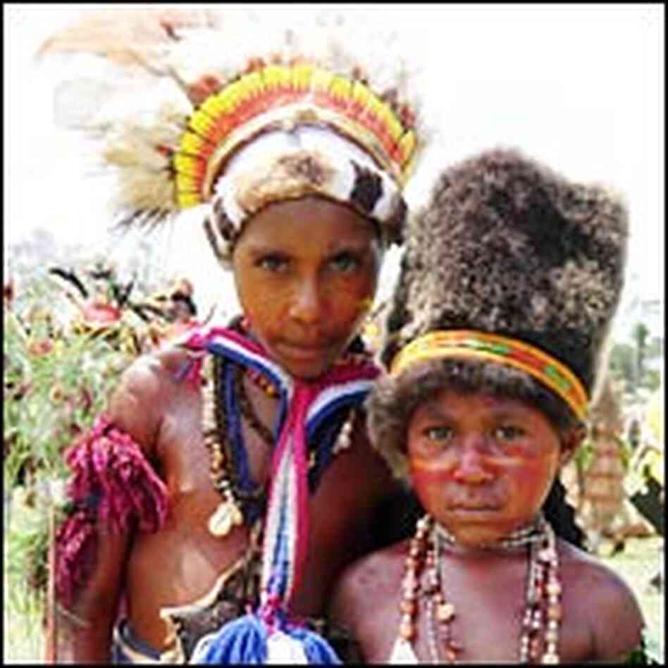 A pair of performers stands in Goroka.