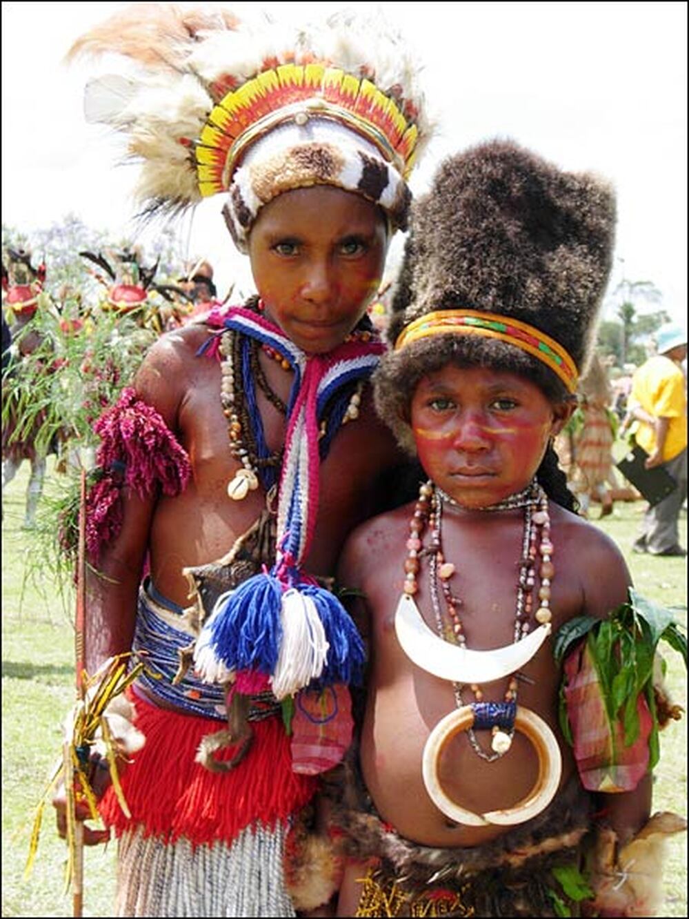A pair of performers stands in Goroka.
