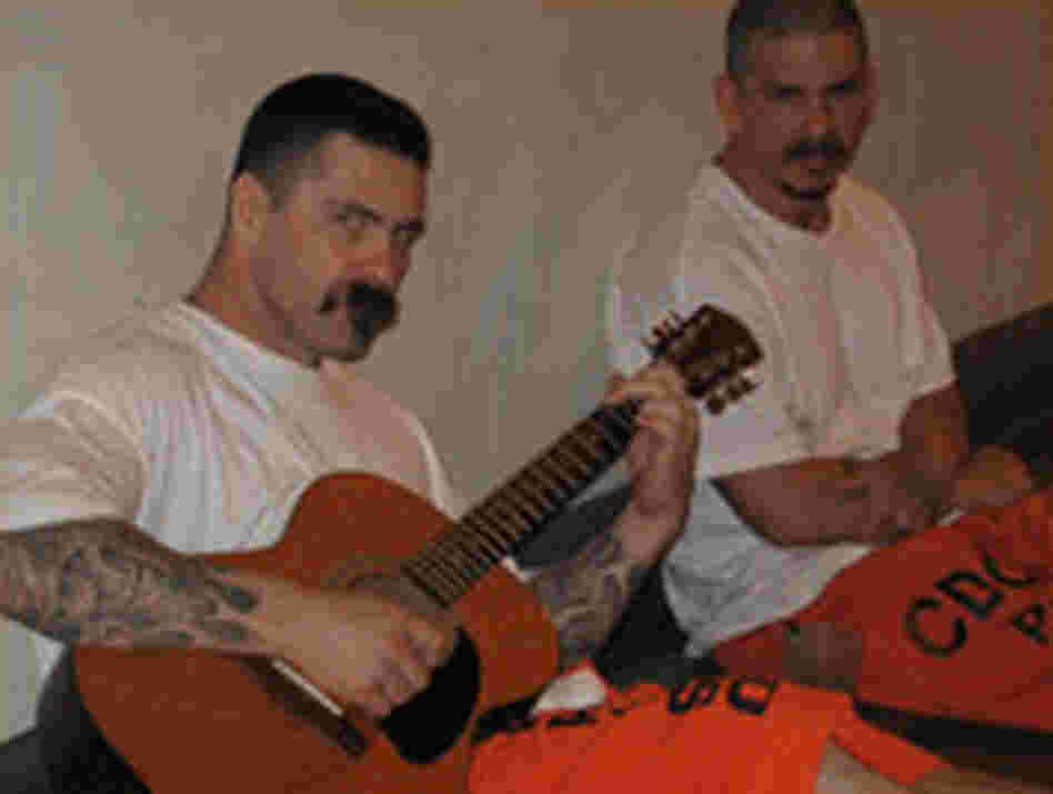 Two inmates with a guitar