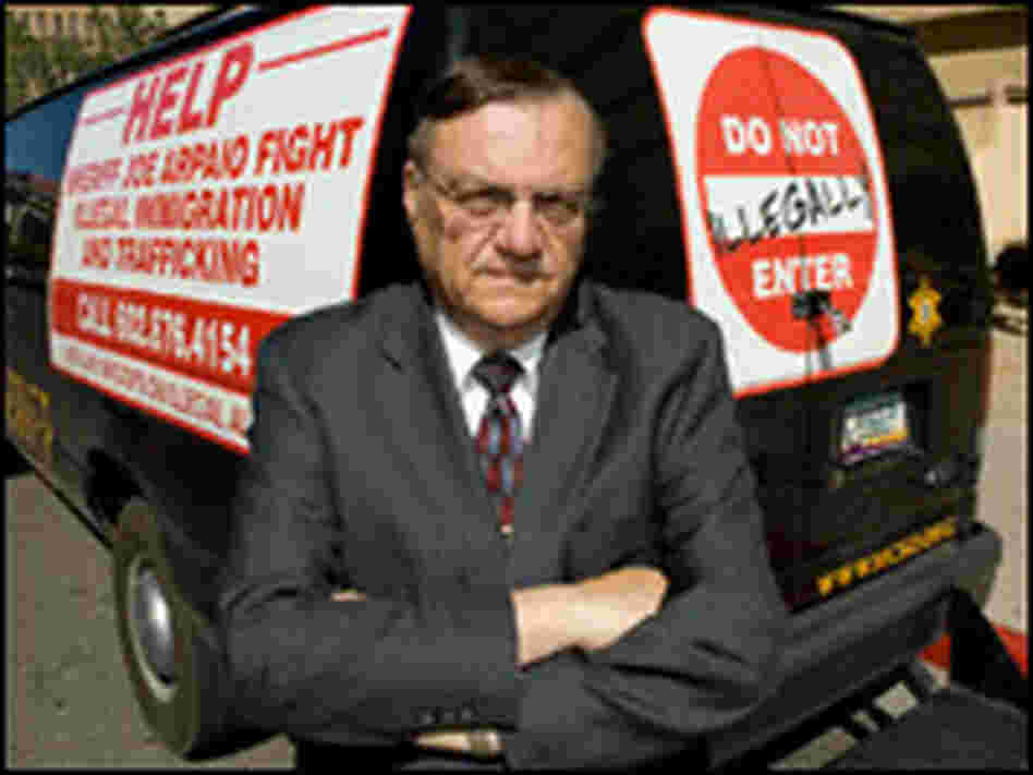 Joe Arpaio  Stands in Front of Transport Vans